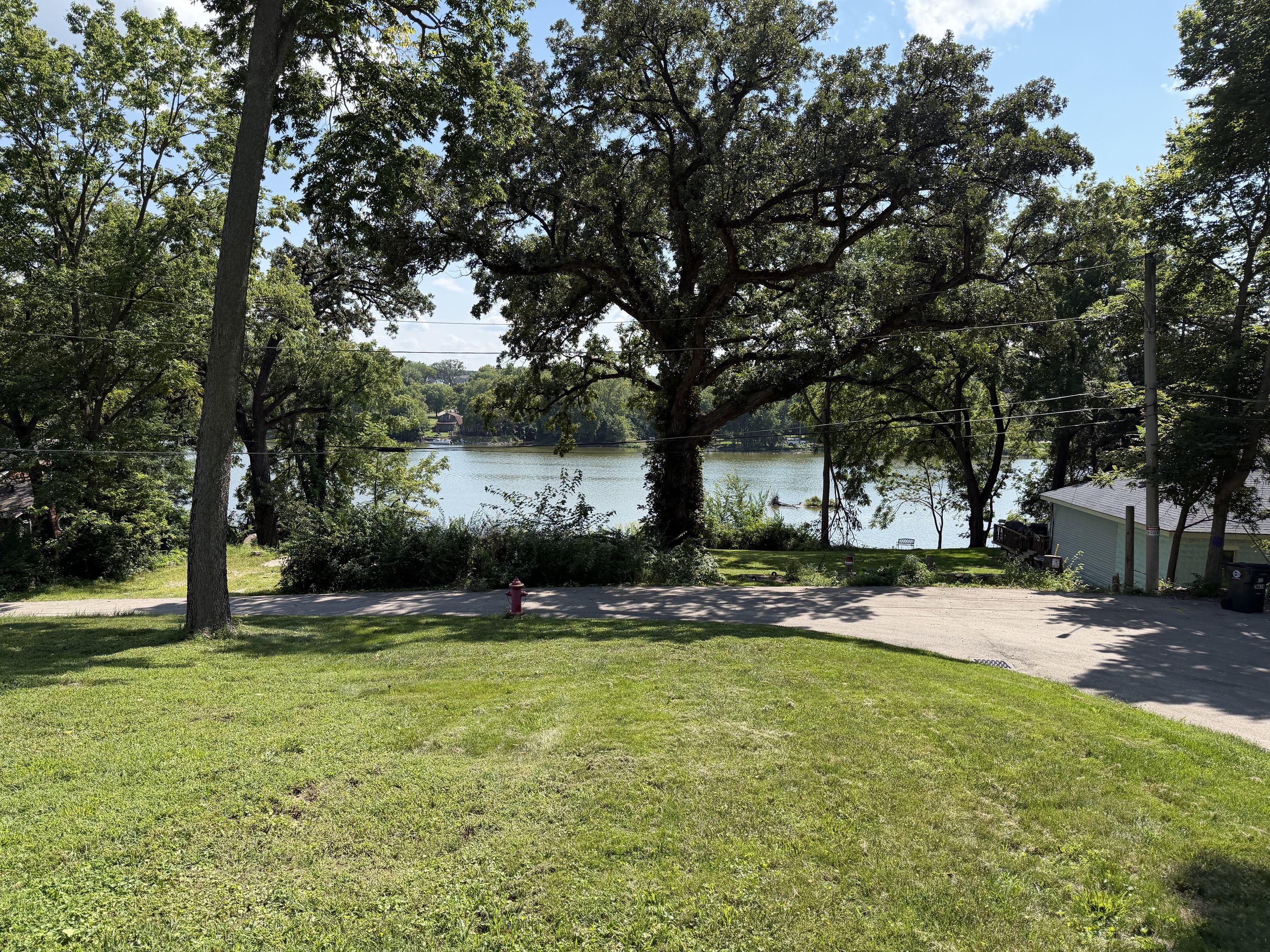 PIN 02-33-129-011. High lot right behind 102 Worsley, looking down at the road and the river.